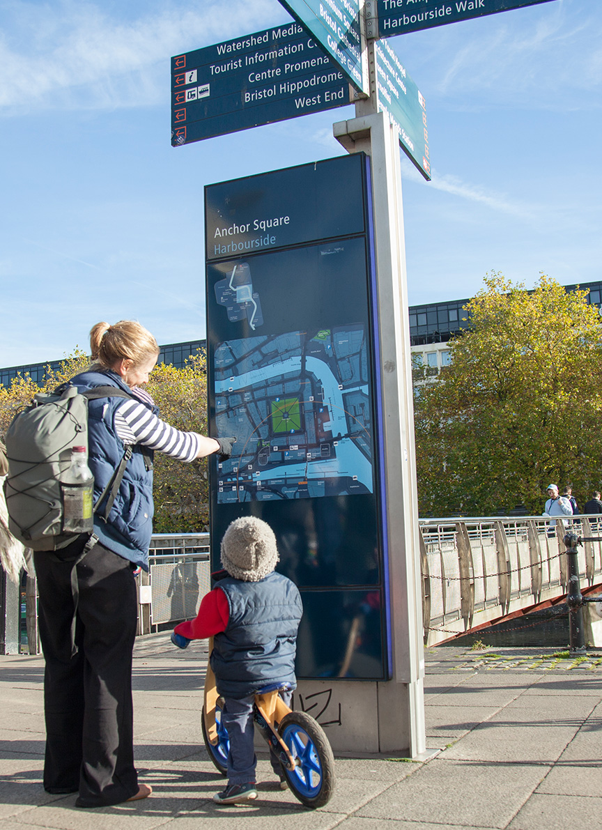 Mother and child looking at sign